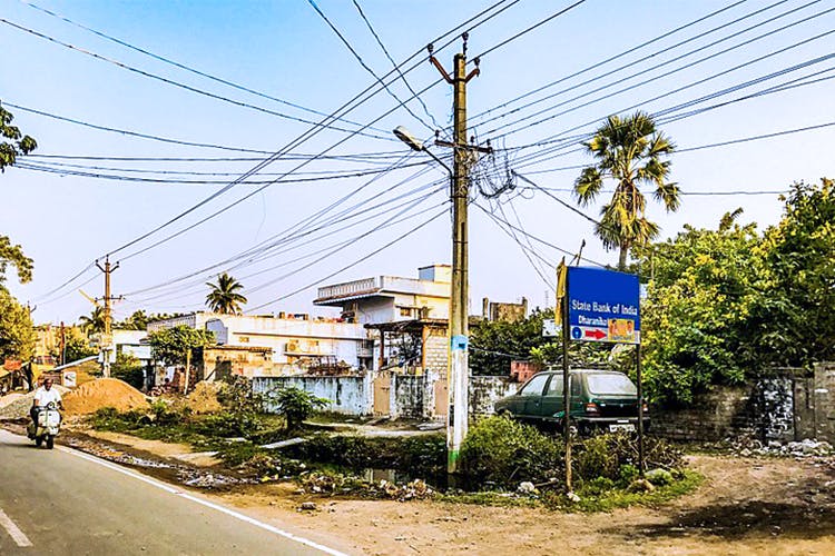 Overhead power line,Residential area,Electricity,Sky,Town,Transport,Neighbourhood,Electrical supply,Road,Tree