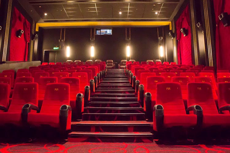 Red,Theatre,Auditorium,Building,Movie theater,Movie palace,Room,Function hall