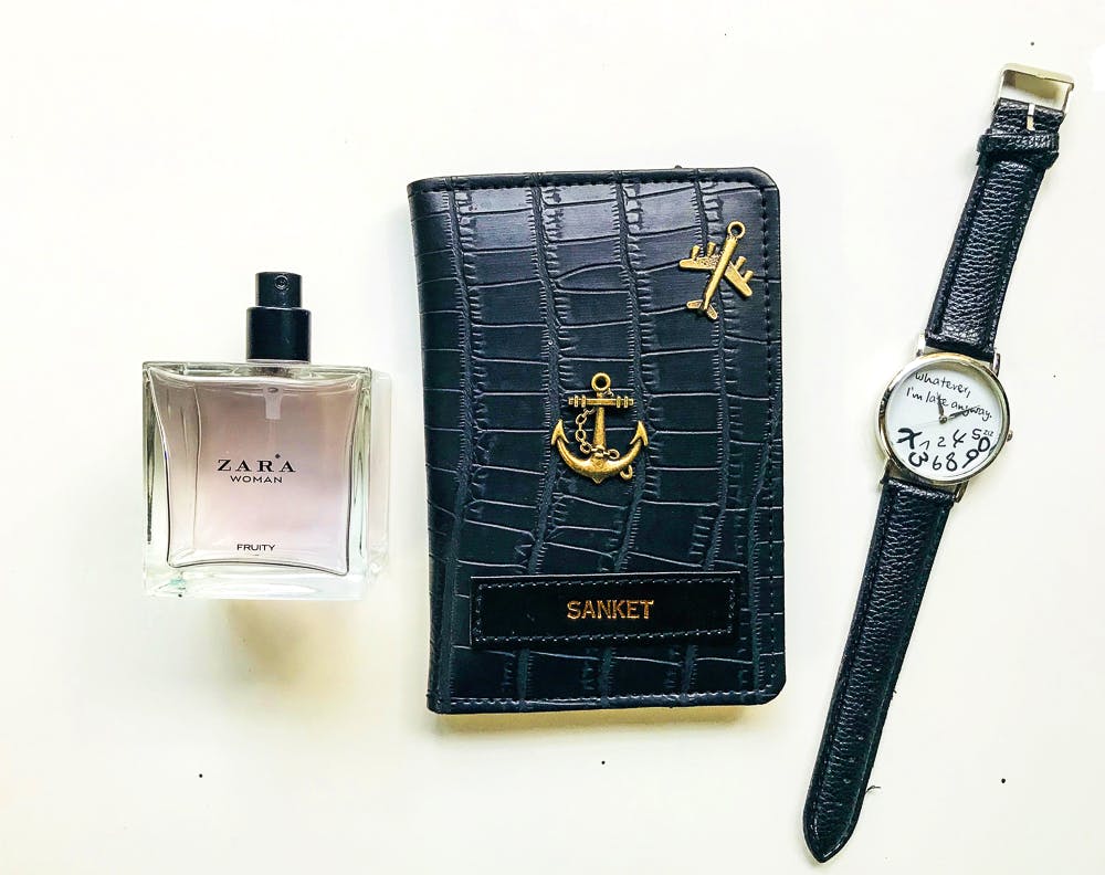 Perfume,Cosmetics,Material property,Watch,Rectangle,Brand,Leather,Strap