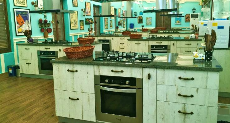 Kitchen,Cabinetry,Furniture,Room,Countertop,Property,Turquoise,Interior design,Kitchen stove,Material property