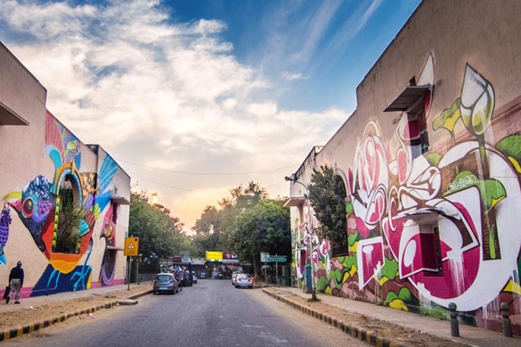 Street art,Street,Urban area,Graffiti,Town,Mural,Art,Sky,Road,Wall