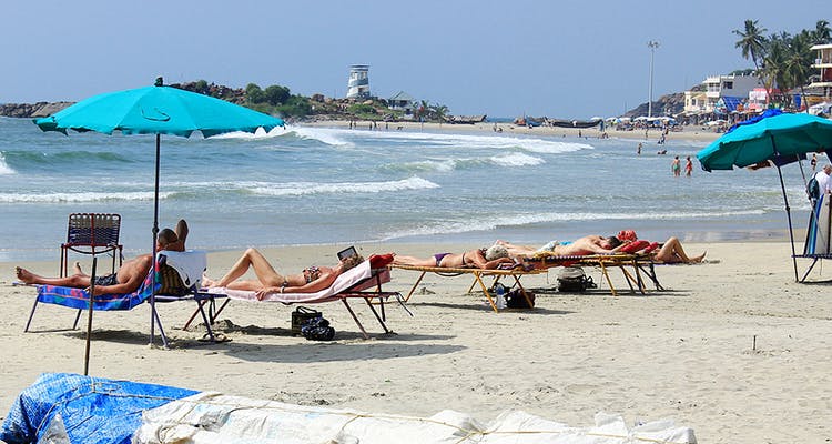 People on beach,Sun tanning,Beach,Sunlounger,Vacation,Tourism,Outdoor furniture,Sand,Sea,Ocean