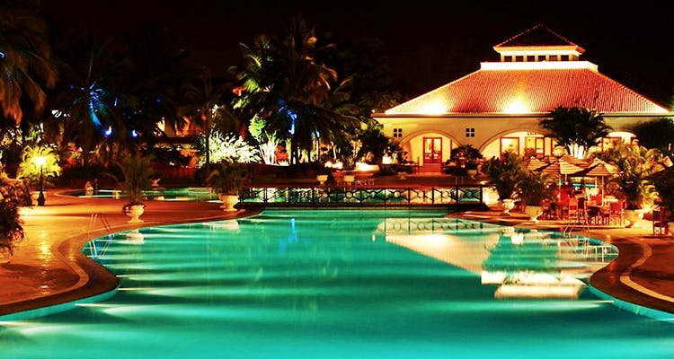 Swimming pool,Resort,Night,Vacation,Lighting,Hotel,Building,Leisure,Palm tree,Resort town