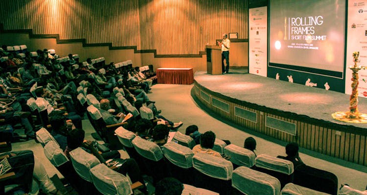 Auditorium,Academic conference,Convention,Audience,Event,Conference hall,Stage,Convention center,Building,Projection screen