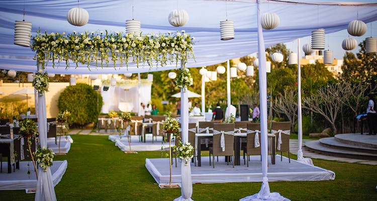 Decoration,Lighting,Function hall,Wedding reception,Ceremony,Table,Building,Interior design,Event,Grass