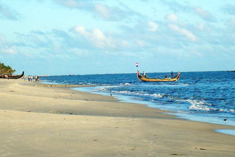 Beach,Sea,Sky,Ocean,Coast,Shore,Vacation,Water transportation,Sand,Boat