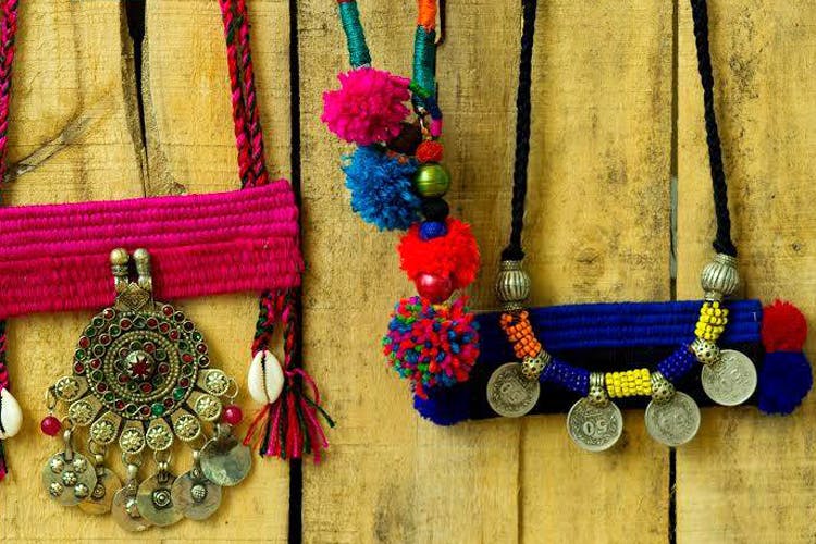 Fashion accessory,Necklace,Medal,Jewellery,Textile,Magenta,Bead,Wool