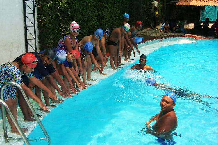 Swimming pool,Leisure,Leisure centre,Swimmer,Recreation,Fun,Swimming,Sports,Individual sports,Headgear