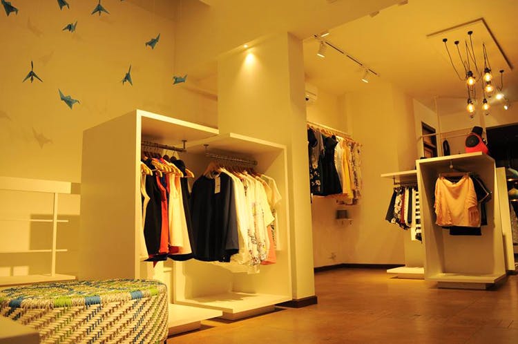 Boutique,Lighting,Room,Interior design,Ceiling,Building,Outlet store,Design,Clothes hanger,Light fixture