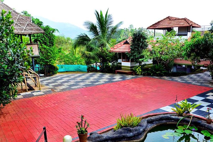 Property,Resort,Swimming pool,Backyard,Landscaping,Real estate,Courtyard,Residential area,Grass,Building
