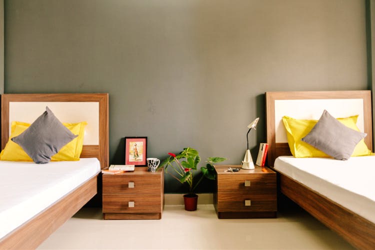 Furniture,Room,Bedroom,Bed,Property,Interior design,Bed sheet,Wall,Yellow,Bed frame