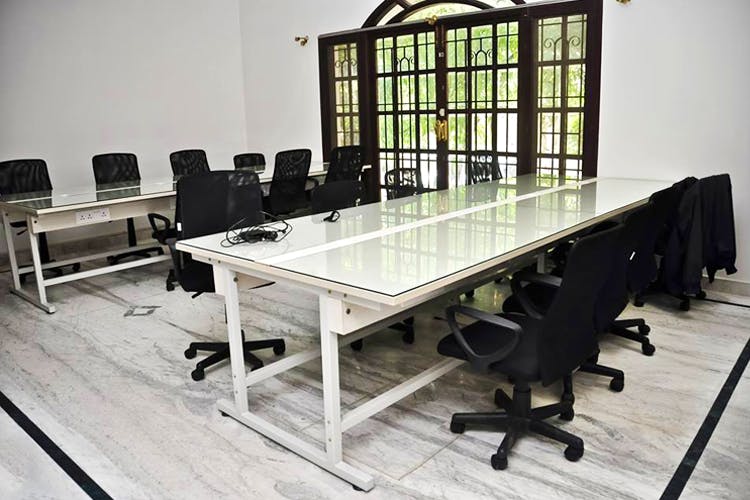 Table,Furniture,Conference hall,Room,Desk,Office,Building,Architecture,Interior design,Chair