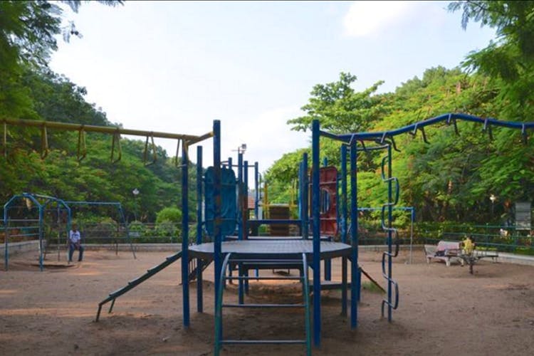 Playground,Public space,Outdoor play equipment,Human settlement,Recreation,Leisure,City,Park,Tree,Nonbuilding structure