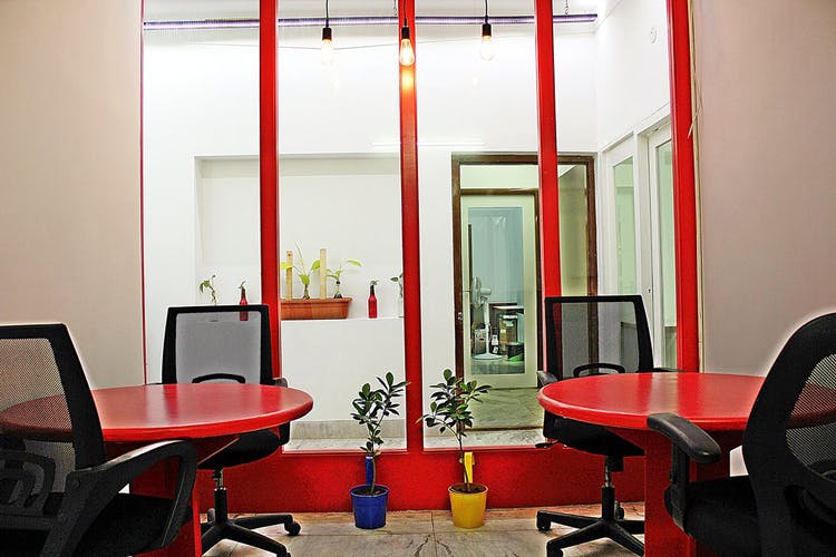 Red,Room,Interior design,Building,Furniture,Architecture,Table,Chair,Office,Floor
