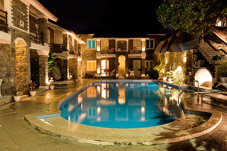 Swimming pool,Property,Building,Lighting,Town,Night,Resort,Real estate,Water,Architecture