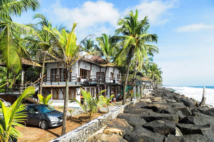 Property,Real estate,Tree,Tropics,Vacation,Resort,House,Shore,Caribbean,Palm tree