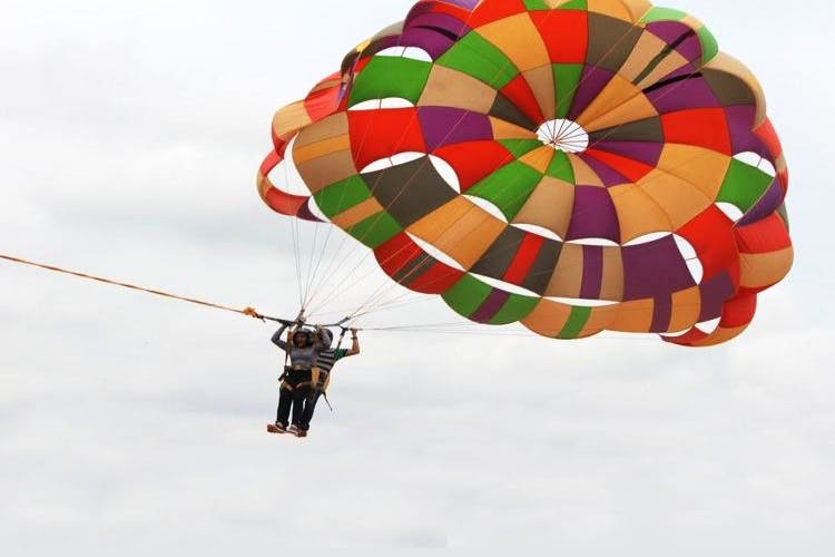 Parachute,Parasailing,Kite sports,Air sports,Windsports,Sky,Surface water sports,Fun,Parachuting,Water sport