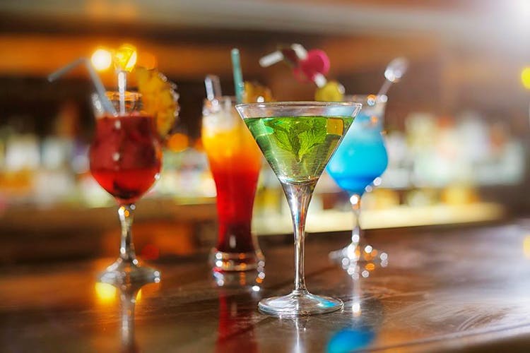 Drink,Classic cocktail,Alcoholic beverage,Distilled beverage,Non-alcoholic beverage,Cocktail,Alcohol,Cocktail garnish,Bar,Blue lagoon