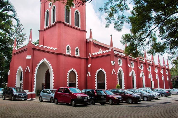 Red,Building,Architecture,Town,Landmark,Vehicle,Car,Church,Place of worship,House
