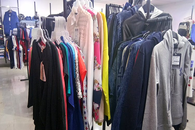 Boutique,Clothing,Outlet store,Outerwear,Room,Bazaar,Textile,Clothes hanger,Dry cleaning