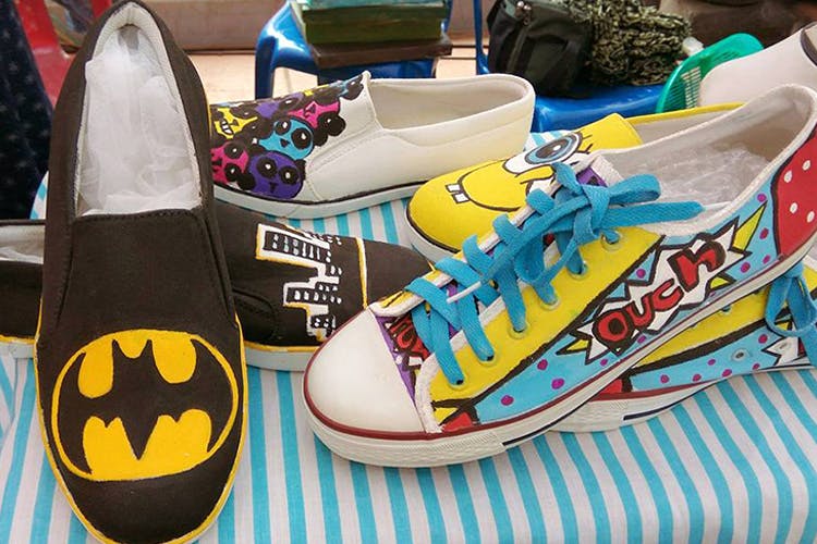 Footwear,Shoe,Sneakers,Yellow,Athletic shoe,Batman,Plimsoll shoe,Walking shoe,Fictional character,Skate shoe