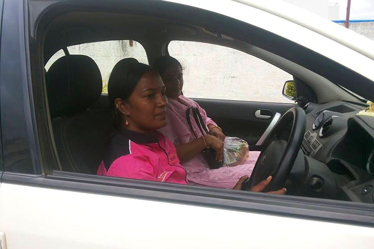 Vehicle door,Vehicle,Car,Pink,Driving,Steering wheel,Family car,Automotive exterior,Plant,Steering part