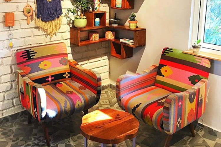 Furniture,Room,Orange,Interior design,Table,Chair,Textile,Living room,Wood,Floor