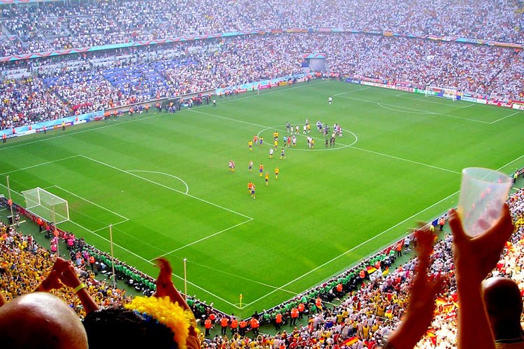 Stadium,Sport venue,Crowd,Arena,Soccer-specific stadium,People,Grass,Player,Team sport,Audience