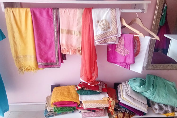 Room,Pink,Furniture,Textile,Curtain,Interior design,Closet,Linens,Canopy bed