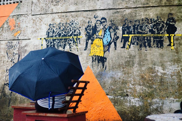 Yellow,Wall,Street art,Umbrella,Art,Visual arts,Mural,Design,Tree,Architecture