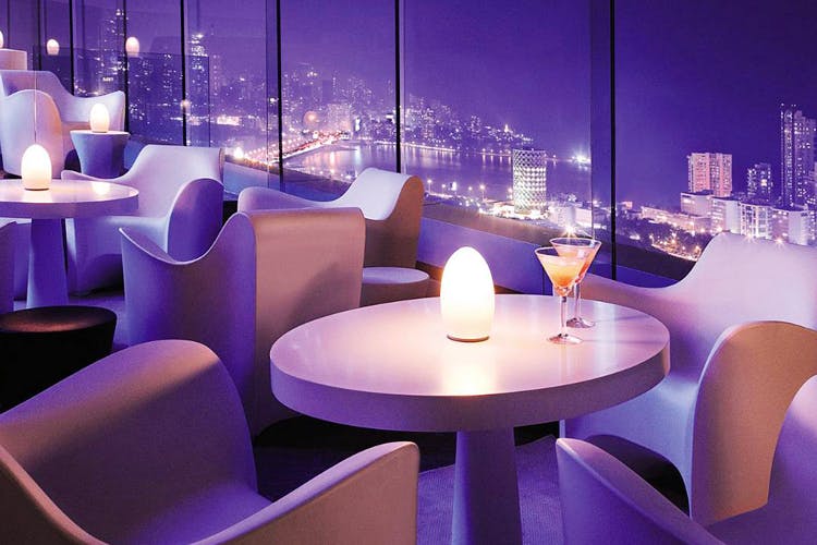 Purple,Lighting,Interior design,Light,Violet,Table,Room,Furniture,Restaurant,Design