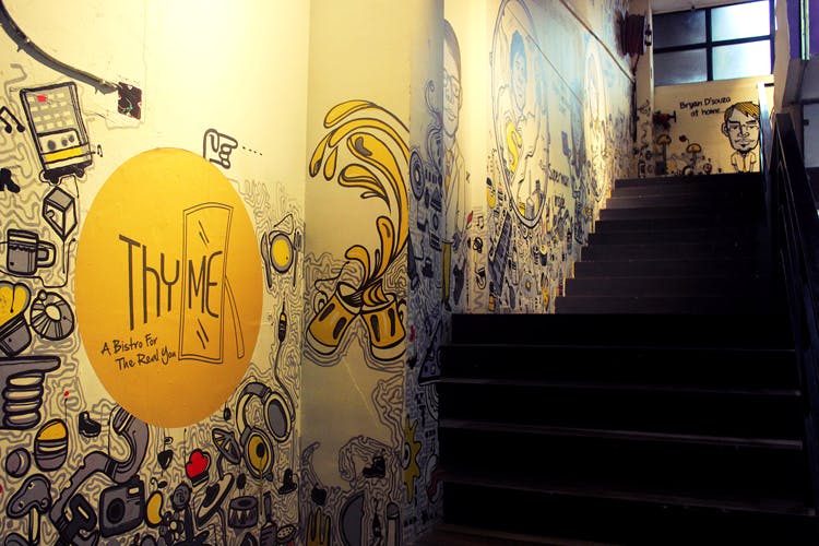 Yellow,Wall,Text,Art,Urban area,Street art,Architecture,Design,Infrastructure,Font