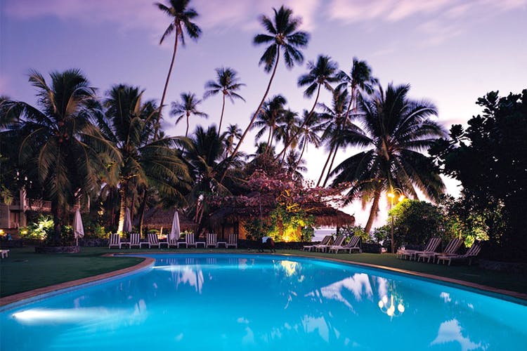 Swimming pool,Resort,Palm tree,Vacation,Tree,Property,Sky,Tropics,Leisure,Arecales