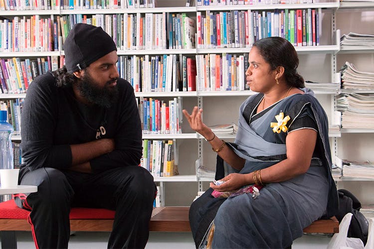 Library,Bookcase,Bookselling,Sitting,Book,Reading,Publication,Shelving,Public library,Conversation