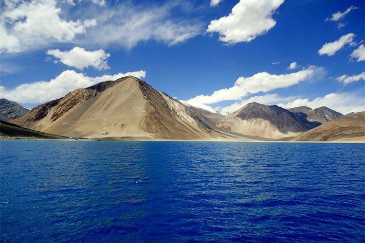 Mountainous landforms,Mountain,Body of water,Highland,Sky,Nature,Lake,Mountain range,Blue,Wilderness