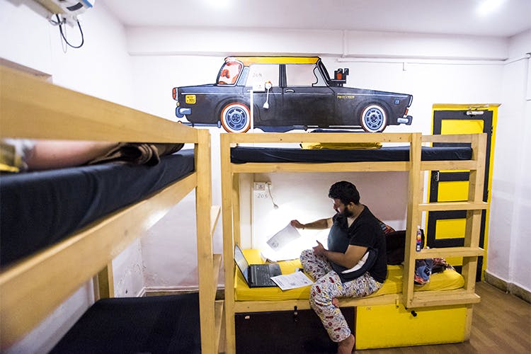 Yellow,Car,Automotive design,Vehicle,Furniture,Room,Bed,Vehicle door,Bunk bed,Family car