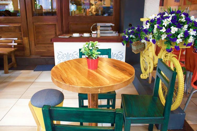 Table,Furniture,Room,Dining room,Interior design,Hardwood,Wood,Kitchen & dining room table,Flower,Chair
