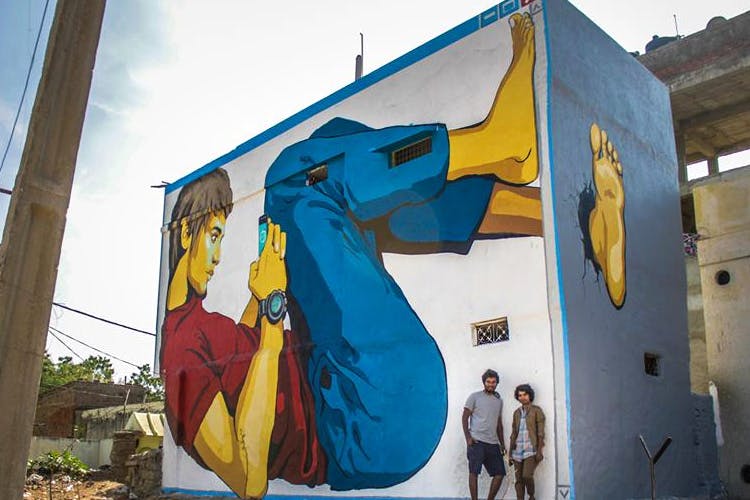 Wall,Mural,Street art,Yellow,Art,Neighbourhood,Visual arts,House,Architecture,Facade