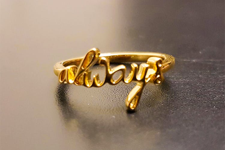 Fashion accessory,Jewellery,Metal,Gold,Body jewelry,Brass,Ring,Font,Finger