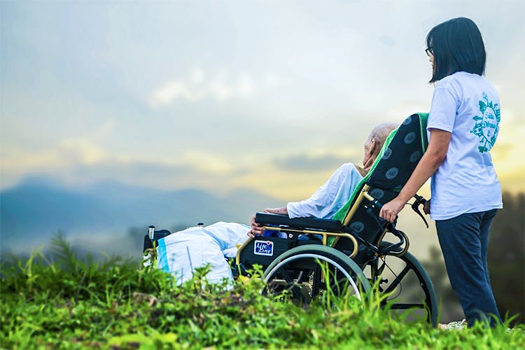 People in nature,Green,Grass,Product,Sky,Grassland,Vehicle,Cloud,Wheelchair,Photography