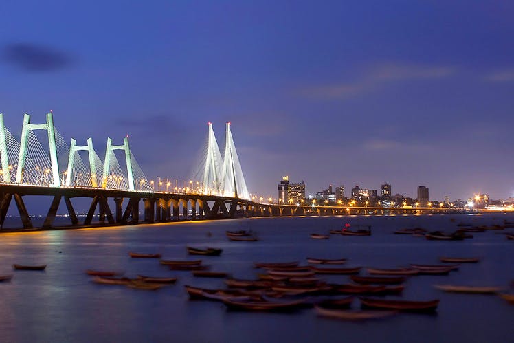 Landmark,Sky,Reflection,Night,Water,Blue,City,Bridge,Light,Metropolitan area